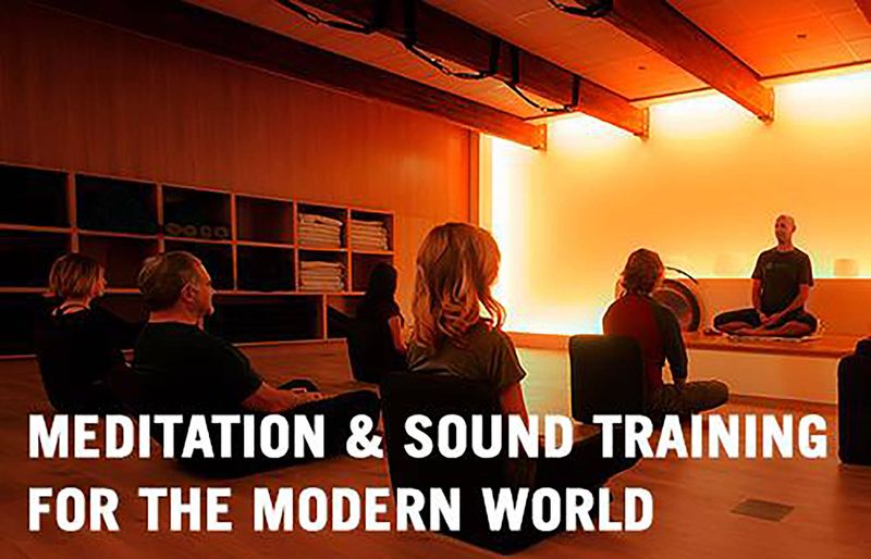 Banner reading meditation and sound training for the modern world, over a room of people seated for a sound meditation
